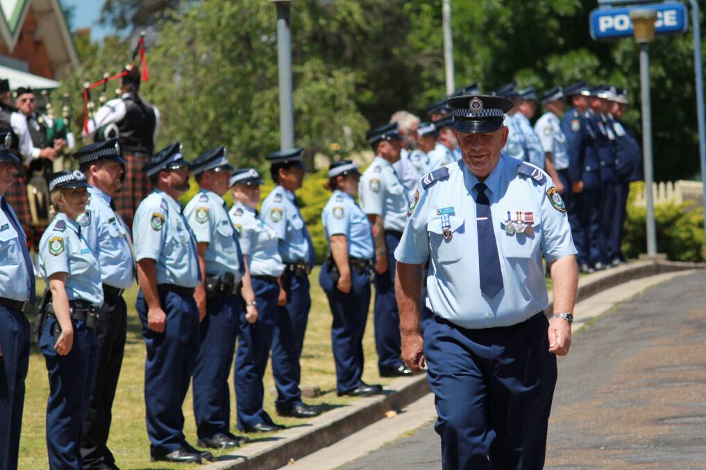 Fond farewell: NSW police officers formed a guard of honour to march Senior Constable Ian Ramma out of Tenterfield Police Station. Photo: NSW Police